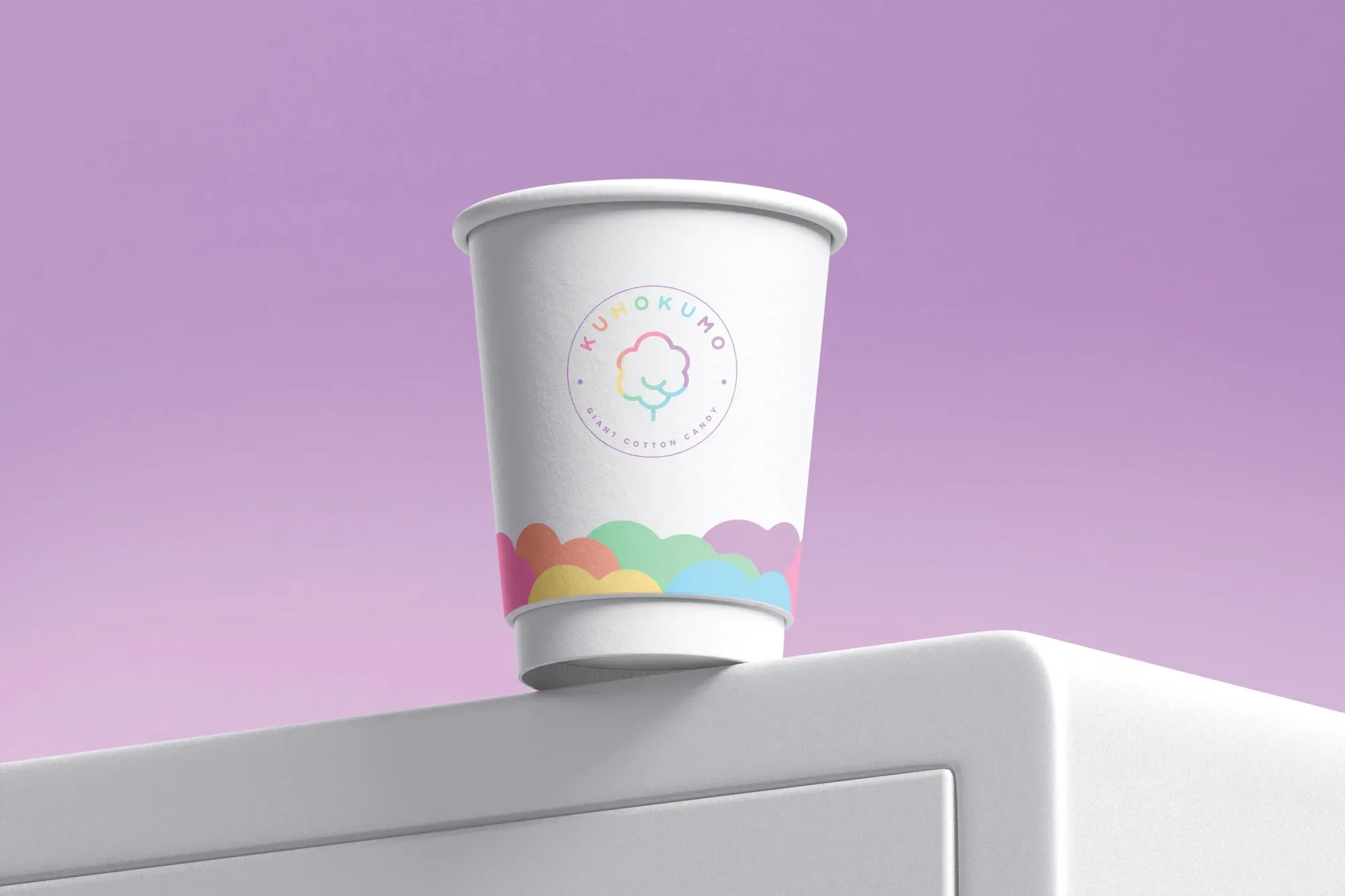 White giant cotton candy in a clear KUMOKUMO cup against a blue sky.
